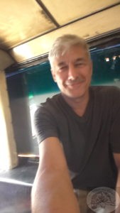 on teh floor at the back of the bus in thailand